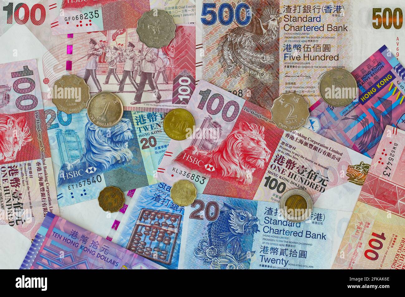 Valuta diversa di Hong Kong, una serie di banconote e monete in dollari Foto Stock