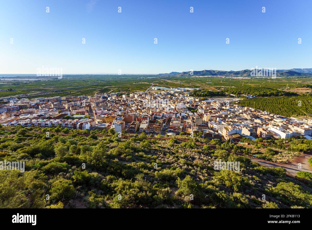 Vista panoramica di una città circondata da vegetazione verde Foto Stock