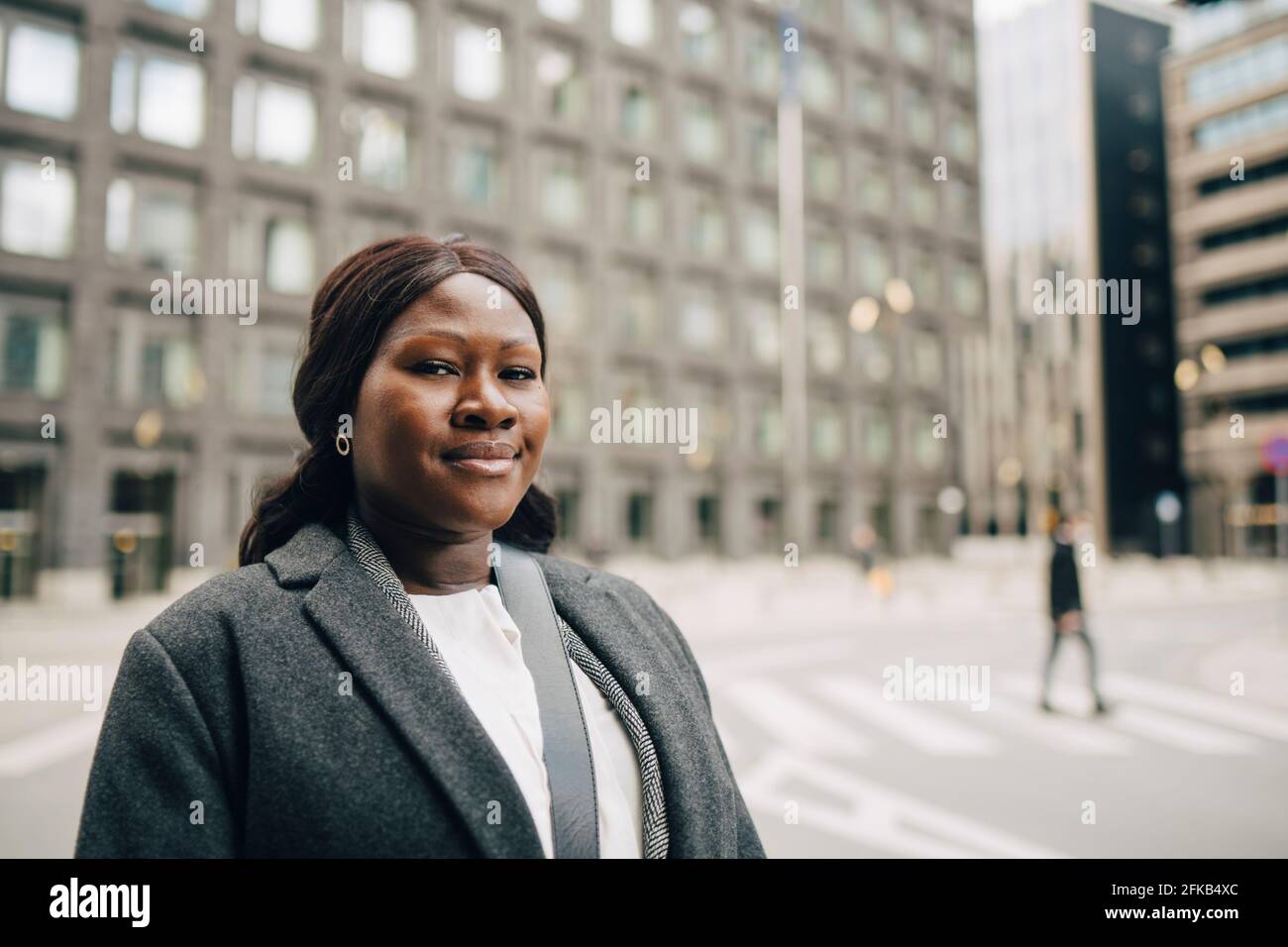 Ritratto di donna d'affari sorridente in città Foto Stock