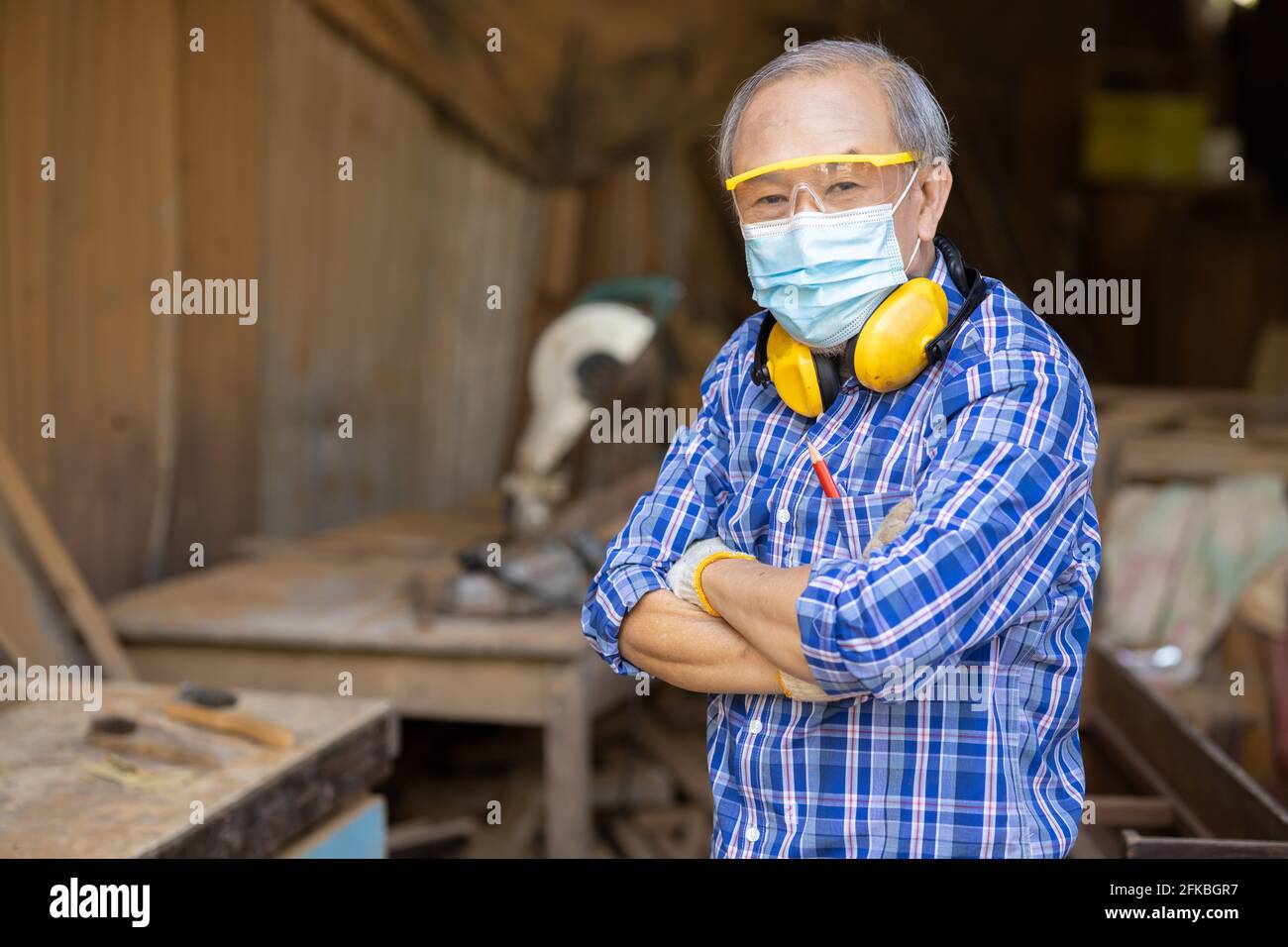 Ritratto di hobby di lavoro di legno anziano per il buon pensionamento, uomo asiatico maturo maestro professionale di legno artigianato mobili uomo produttore di legno. Foto Stock