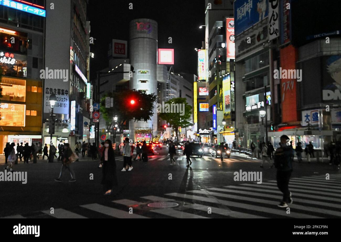 Tokyo, Giappone. 30 Apr 2021. I pedoni che indossano maschere facciali camminano all'incrocio di Shibuya a Tokyo, Giappone, venerdì 30 aprile 2021. Il governatore di Tokyo Yuriko Koike ha chiesto di spegnere i cartelli al neon dopo le 20:00 durante il terzo stato di emergenza per COVID-19 dal 25 aprile al 11 maggio. Foto di Keizo Mori/UPI Credit: UPI/Alamy Live News Foto Stock