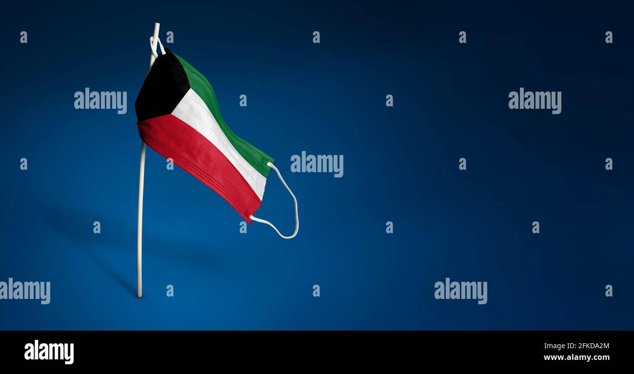 Maschera Kuwait su sfondo blu scuro. Bandiera ondulata del Kuwait dipinta su maschera medica sul palo. Concetto del banner della lotta contro l'epidemia Foto Stock