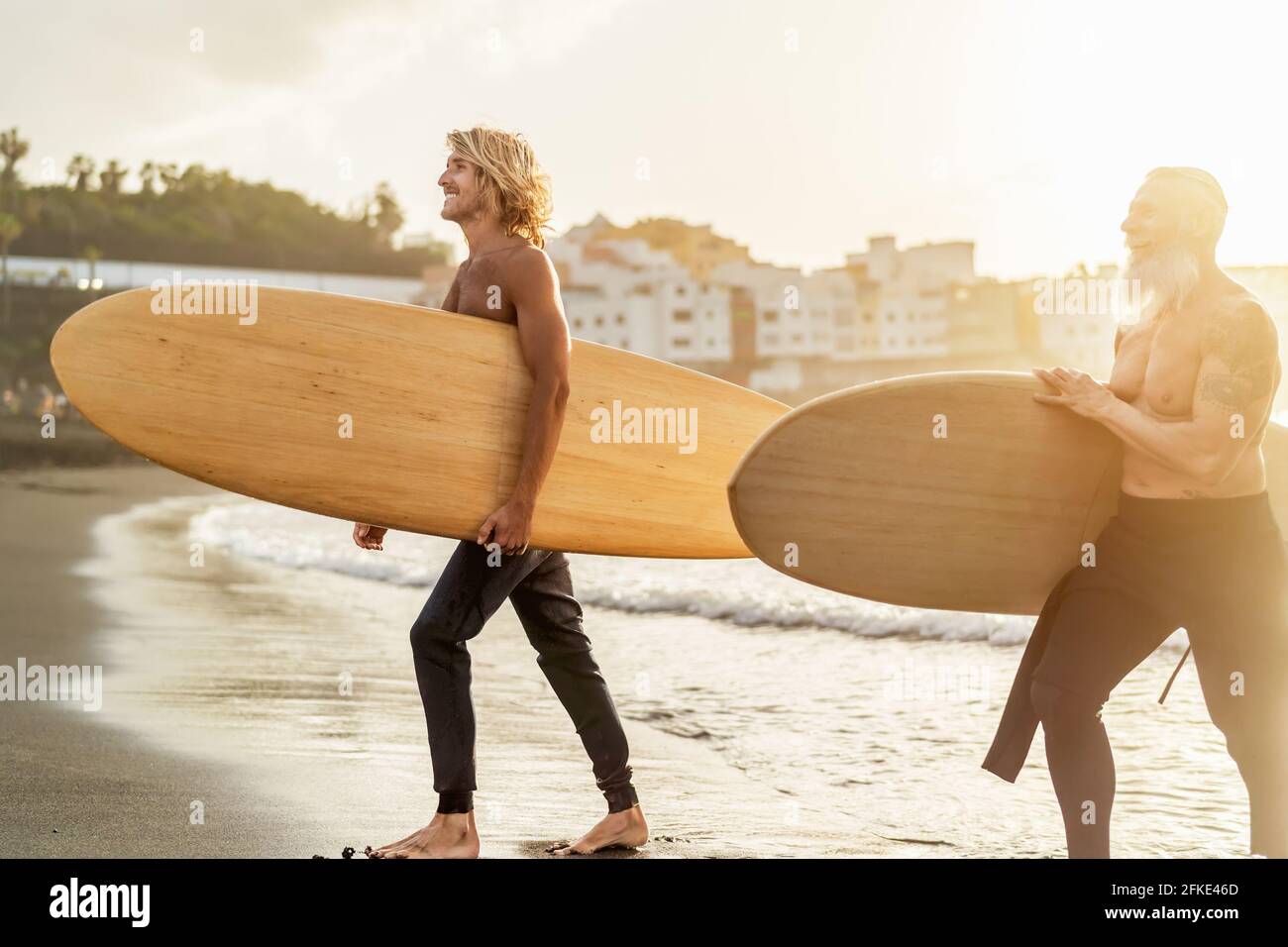 Amici felici con diverse età surf insieme - persone sportive Divertirsi durante la giornata di surf in vacanza - stile di vita sportivo estremo concetto Foto Stock