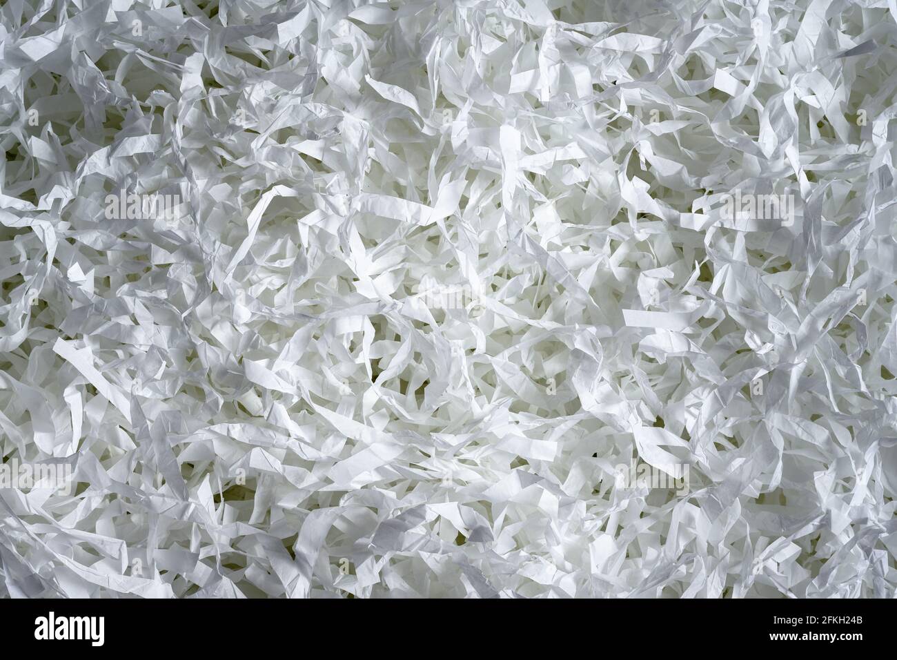 Sfondo a trama di carta sminuzzata, vista dall'alto di molte strisce di carta bianca. Pila di carta tagliata come confetti per partito o riempitivo per spedizione fragile i Foto Stock