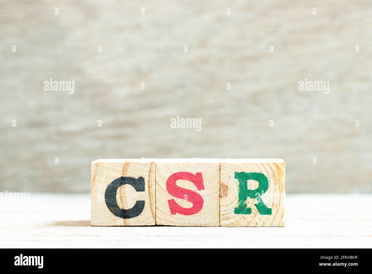 Blocco di lettere alfabetiche nella parola CSR (Abbreviazione di responsabilità sociale d'impresa) su sfondo di legno Foto Stock