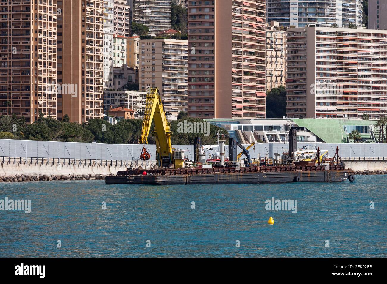 Nave industriale con gru durante la costruzione di frangiflutti a Monaco Principato costruzione di appartamenti e condomini Foto Stock