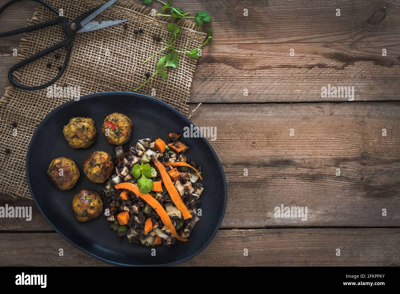 Palle di verdure grigliate con insalata di lenticchie su un tavolo rustico in legno, concetto di cibo vegano, vista dall'alto con spazio per la copia Foto Stock