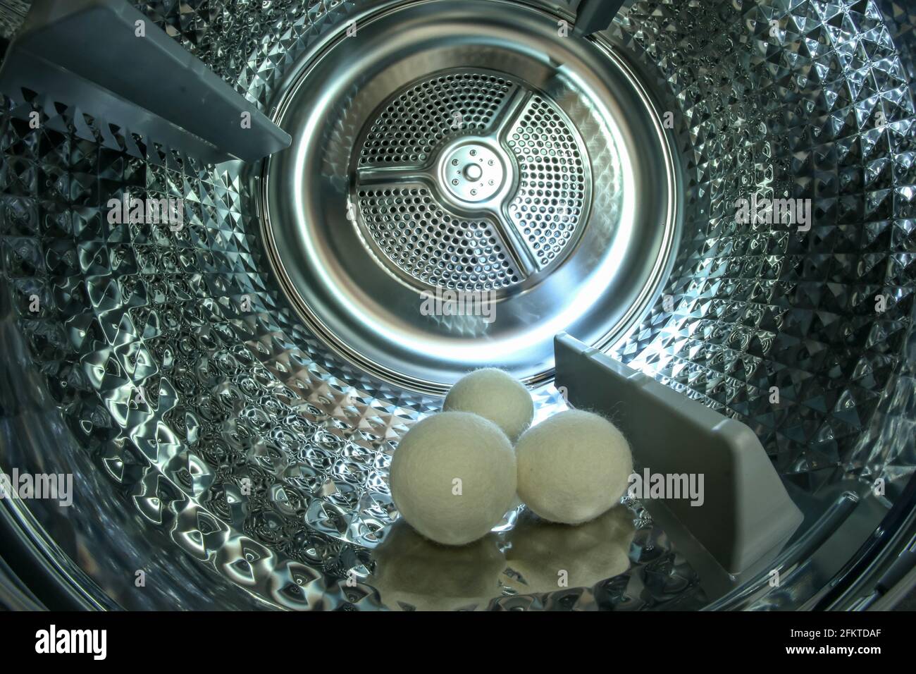 Lo sguardo all'interno del tamburo metallico lucido del moderno asciugatore  con tre sfere che aiutano ad asciugare i vestiti più velocemente Foto stock  - Alamy