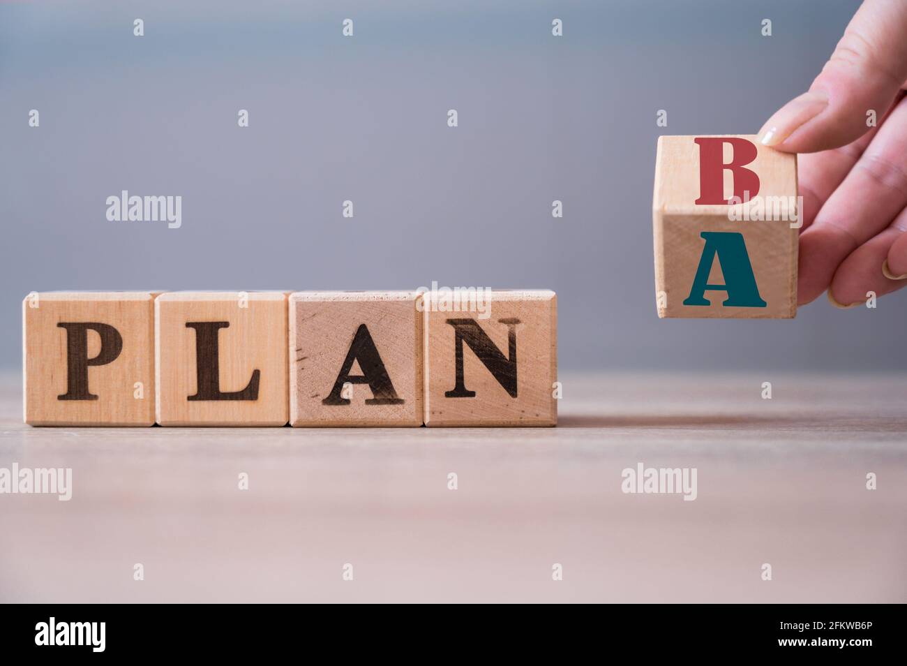 Flip mano cubo di legno con la parola PIANO A per PIANIFICARE B su sfondo di legno. Concetto aziendale Foto Stock