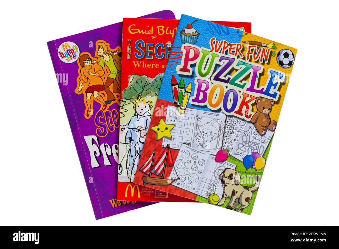 Mucchio di libri per bambini con Super Fun Puzzle Book on parte superiore isolata su sfondo bianco Foto Stock