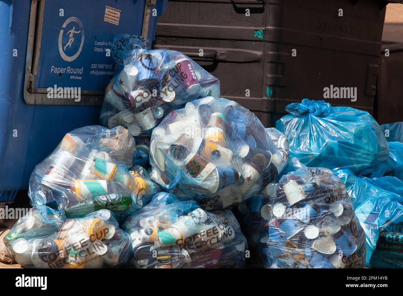 Londra, Regno Unito, 30 aprile 2021: Un cumulo di sacchetti di plastica blu contenenti tazze da caffè monouso attende di essere raccolto per il riciclaggio su Tooley Street, accanto Foto Stock