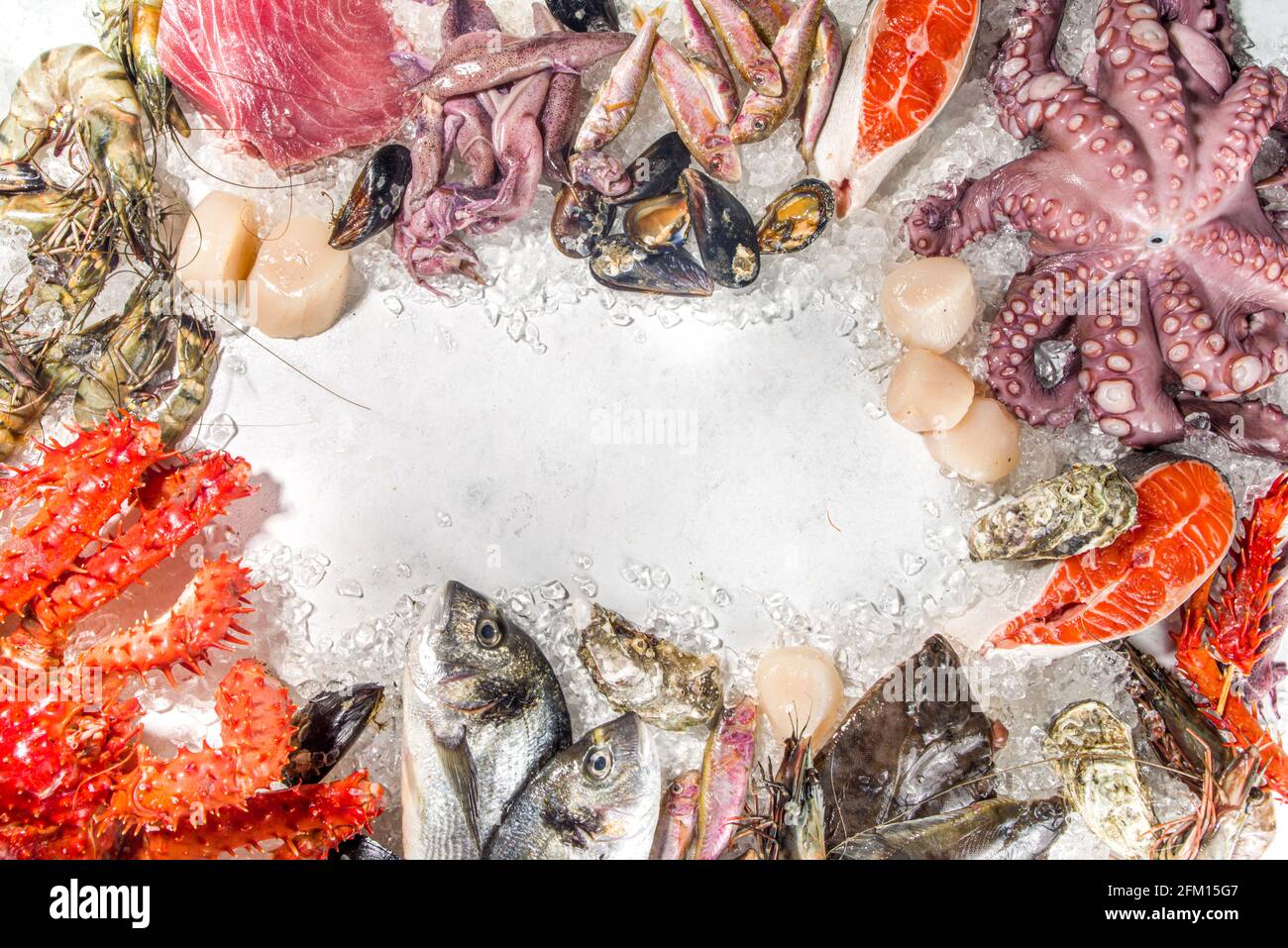 Insieme di vari frutti di mare freschi crudi - polpo, granchio, calamari, gamberetti, ostriche, cozze, salmone tonno dorada pesce con spezie di erbe limone, dorso bianco Foto Stock