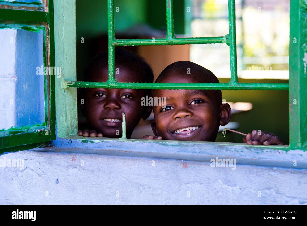 Due bambini che guardano fuori dalla loro classe a scuola a livingstone zambia Foto Stock