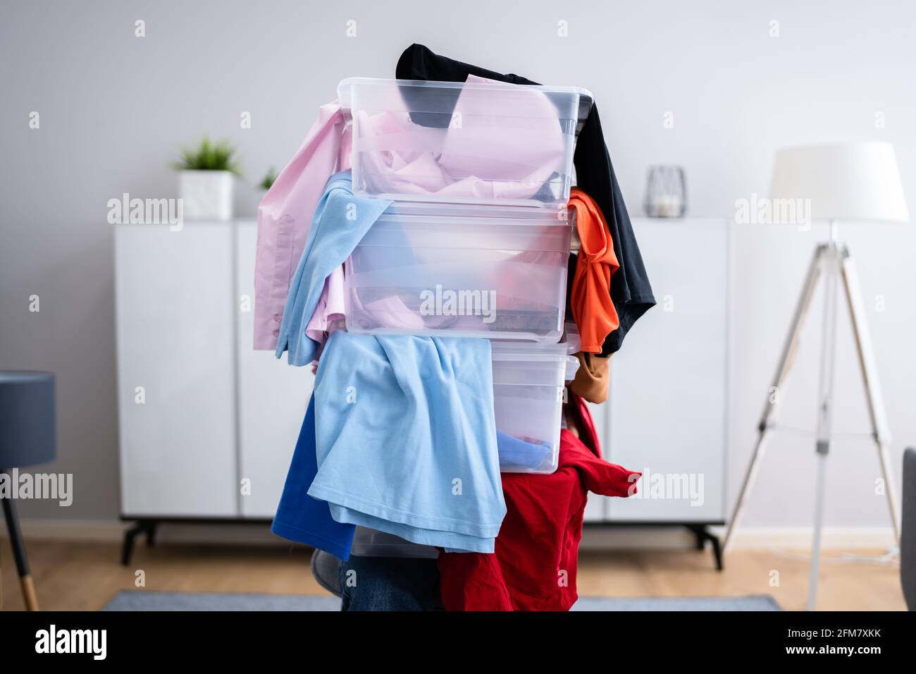 Donna decluttering e facendo lavanderia a casa Foto Stock