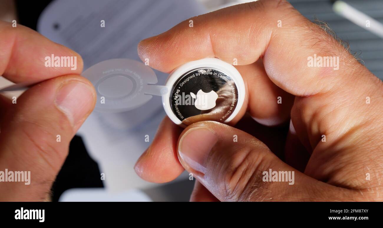 Un pov che disimballa la rimozione della pellicola di plastica da AirTag  Foto stock - Alamy