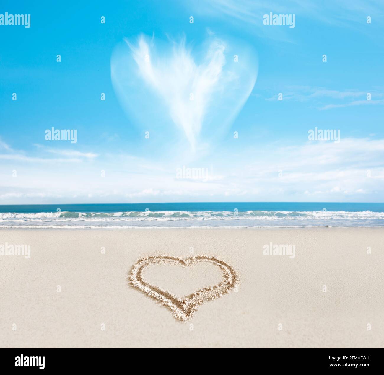 Nuvola il cuore su un cuore nella sabbia sul spiaggia Foto Stock