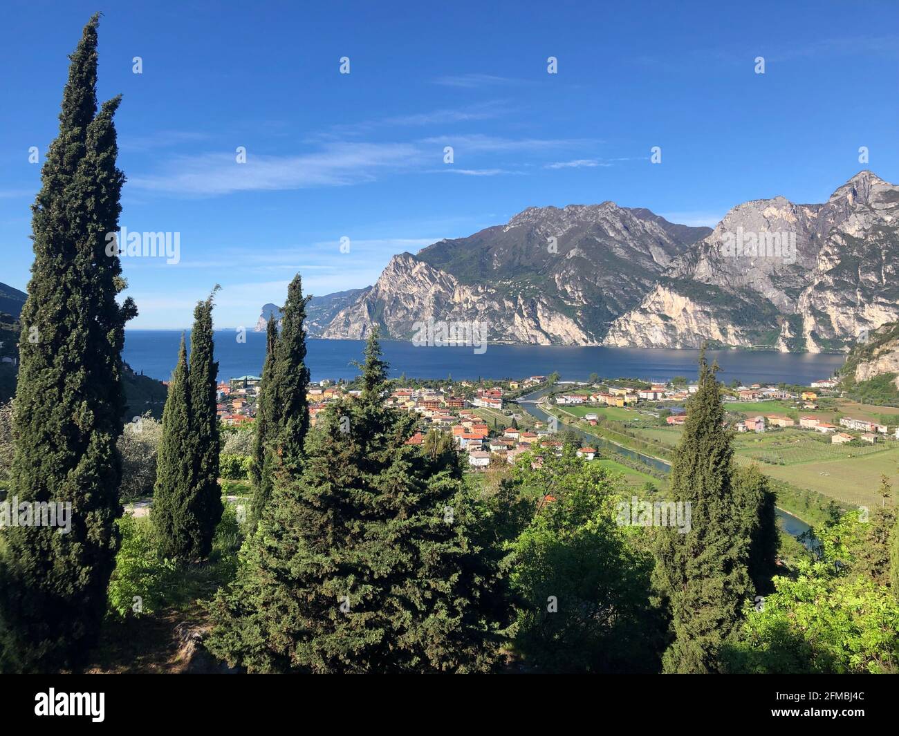 Vista sul lago di Garda settentrionale, cipressi, cielo blu, lago blu, natura, Torbole, Nago-Torbole, Gardaseberge, Trentino, Alto Adige, Italia Foto Stock