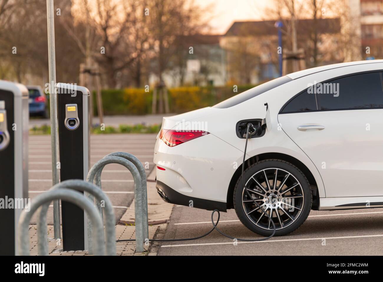 Un'auto completamente elettrica presso una stazione di ricarica Foto Stock