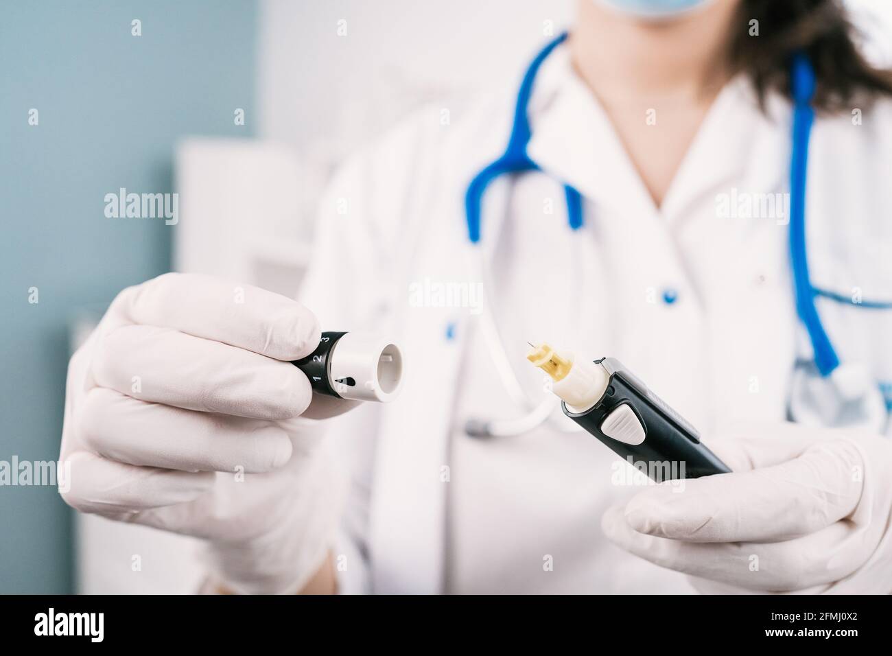 Coltivare un'infermiera femminile non riconoscibile in guanti sterili con il prelievo di sangue dispositivo al lavoro in ospedale Foto Stock