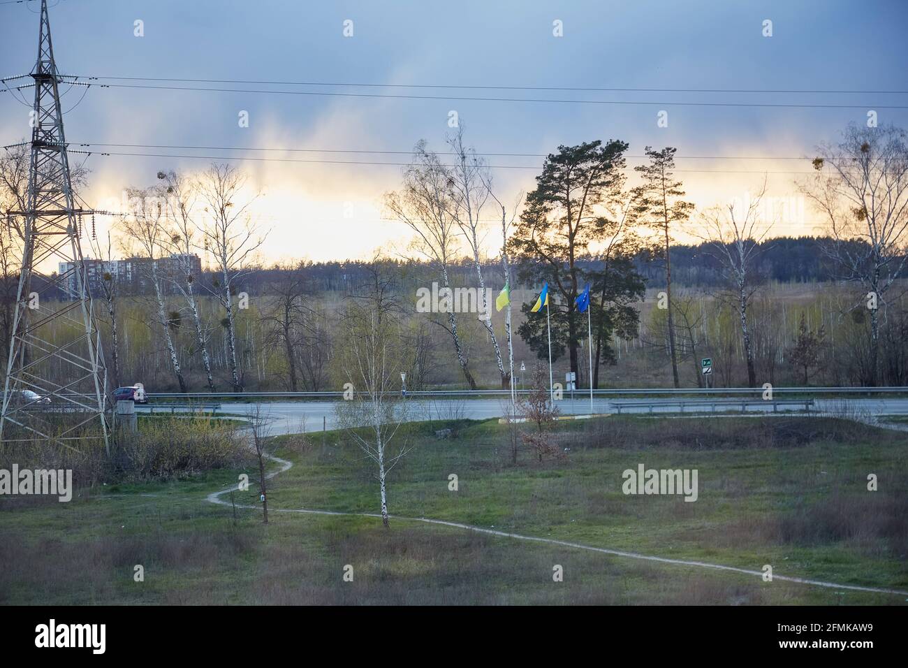Vista dalla finestra sulla città verde sera in primavera. Bandiera dell'Ucraina e bandiera dell'Unione europea. Foto di alta qualità Foto Stock