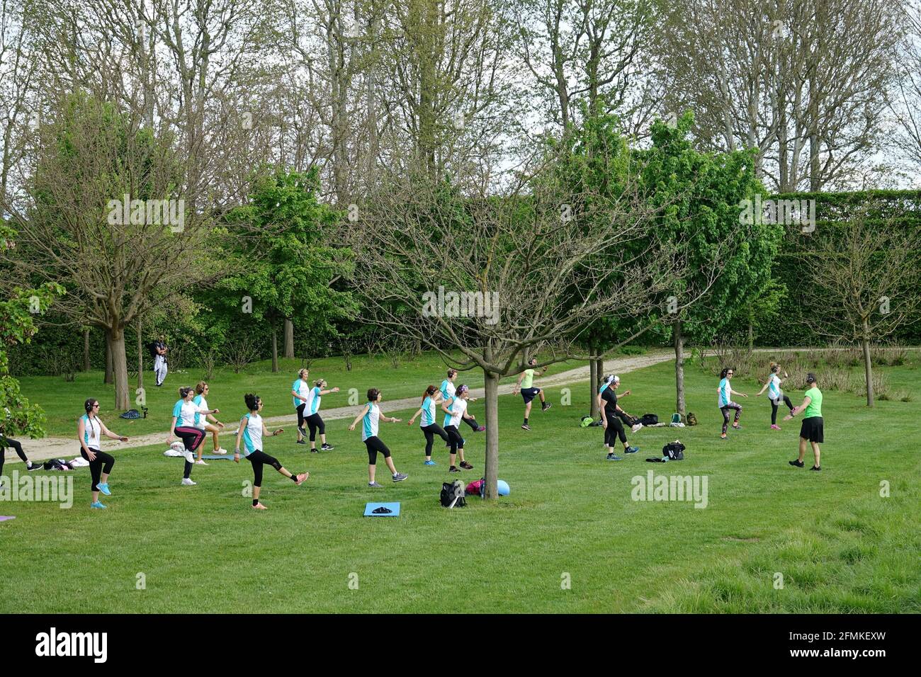 Allenamento all'aperto. Aria aperta. Le persone che fanno esercizio di gruppo nel parco mantenendo la distanza l'una dall'altra. Distanza sociale dopo covid-19 coronavirus qu Foto Stock
