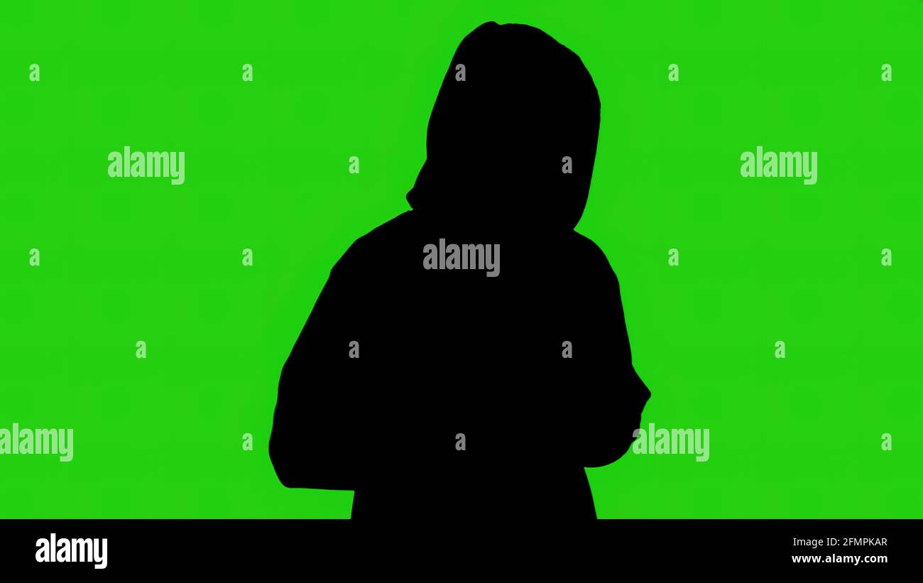 Silhouette nera del commerciante di droga su sfondo verde Foto Stock