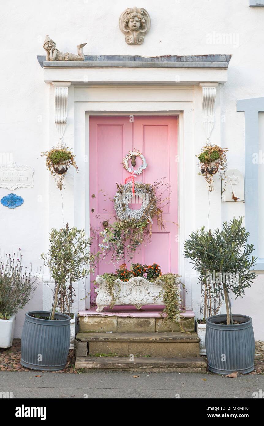 BUCKINGHAMSHIRE, Regno Unito - 25 dicembre 2020. Porta d'ingresso rosa ornato di casa d'epoca decorata con un ghirlanda di Natale. Inghilterra, Regno Unito Foto Stock