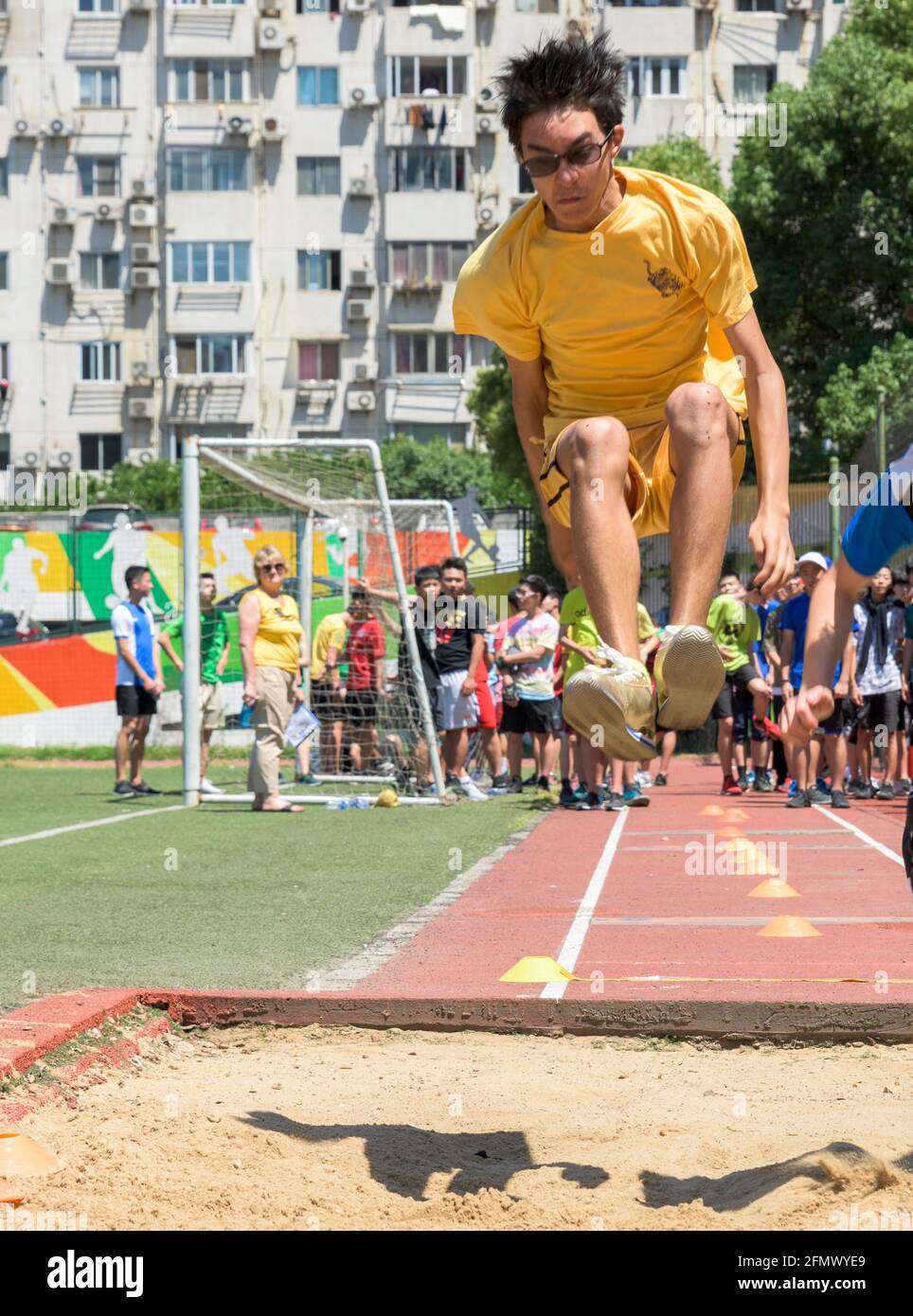Gli studenti delle scuole superiori compete nell'evento di salto di lunga durata della pista e della giornata di campo a Shanghai, in Cina. Foto Stock