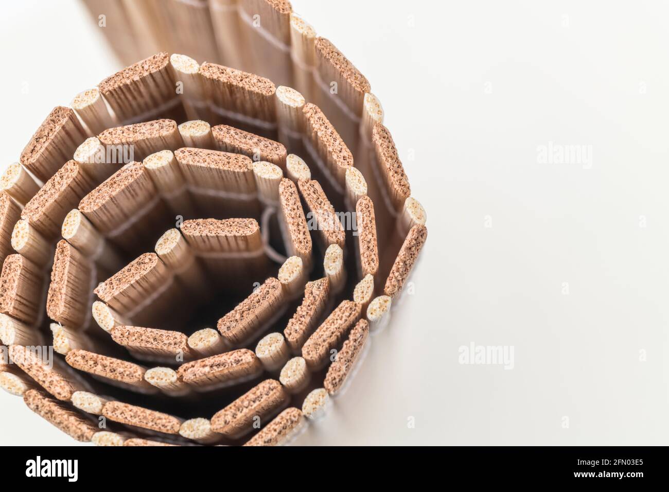 Immagine ravvicinata di tappeto da tavolo in bambù ecologico arrotolato / texture placemat. Per prodotti di legno sostenibili / prodotti forestali. Foto Stock