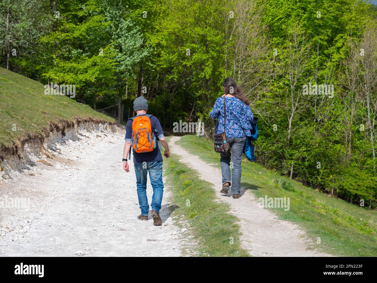 Una coppia a piedi o a piedi lungo un sentiero pubblico di campagna su Monarch's Way in Arundel Park, South Downs National Park ad Arundel, West Sussex, Regno Unito Foto Stock