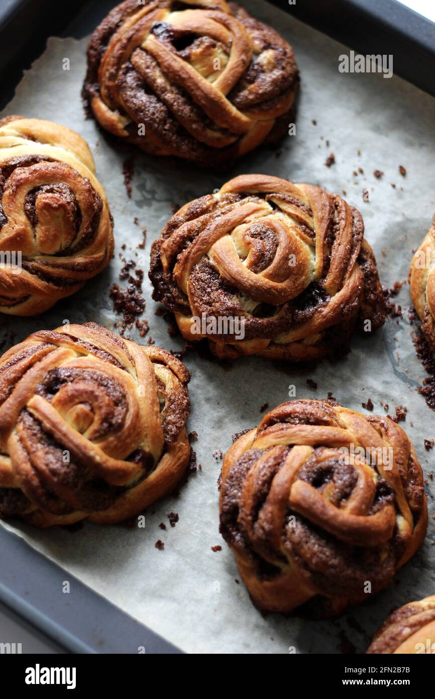 Panificio. Ciambelle di cannella sulla griglia da forno. Prima colazione pasticceria. Foto Stock