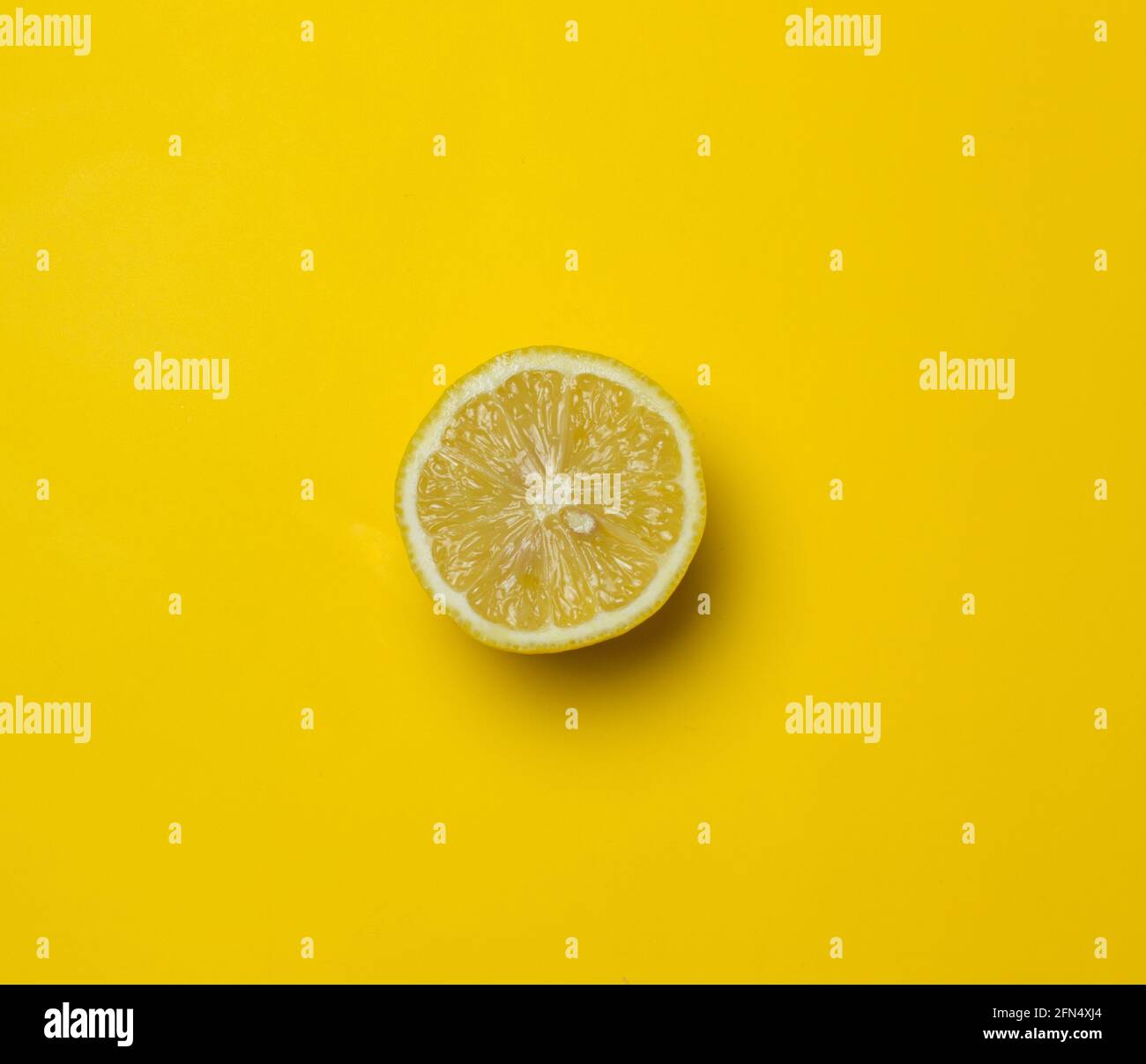 mezzo limone su sfondo giallo Foto Stock
