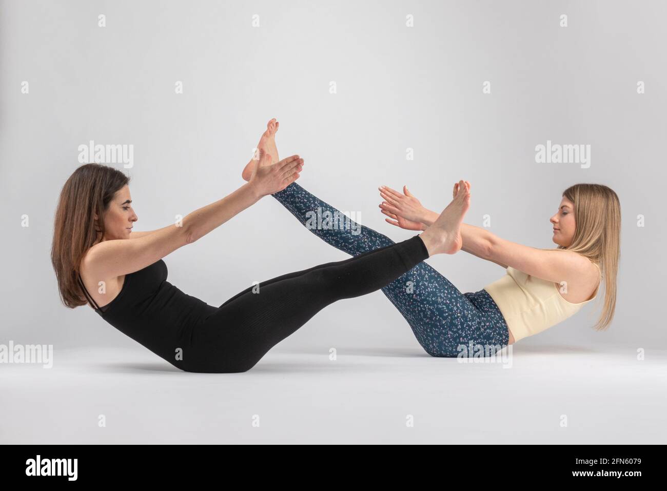 due ragazze che fanno cento pilates postura Foto Stock