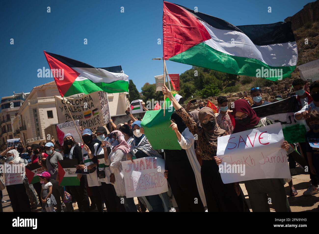 Malaga, Spagna. Maggio 15 2021: I manifestanti che indossano maschere di protezione tengono cartelli e bandiere palestinesi mentre prendono parte a una protesta contro l'apartheid israeliana e ad un attacco armato a Gaza in via Alcazabilla. Diverse organizzazioni a favore dell'autodeterminazione della Palestina chiedono la fine dei bombardamenti a Gaza e il genocidio contro la popolazione palestinese, Dopo i bombardamenti su Gaza e i violenti attacchi tra le forze di sicurezza israeliane e i palestinesi a Gerusalemme. I manifestanti hanno anche chiesto la libertà per l'operatrice sanitaria spagnola Juana Sanchez arbitrariamente detenuta e incarcerata dalle forze israeliane. Credito: SOPA Foto Stock