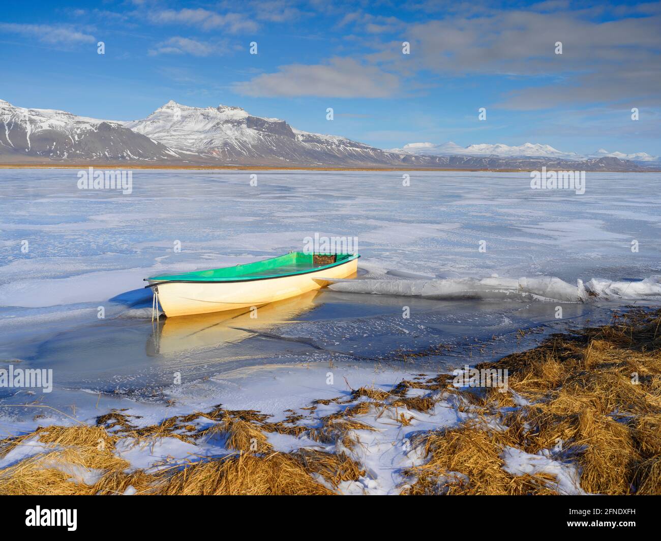 Una barca a remi congelata in ghiaccio su un lago in Islanda Foto Stock