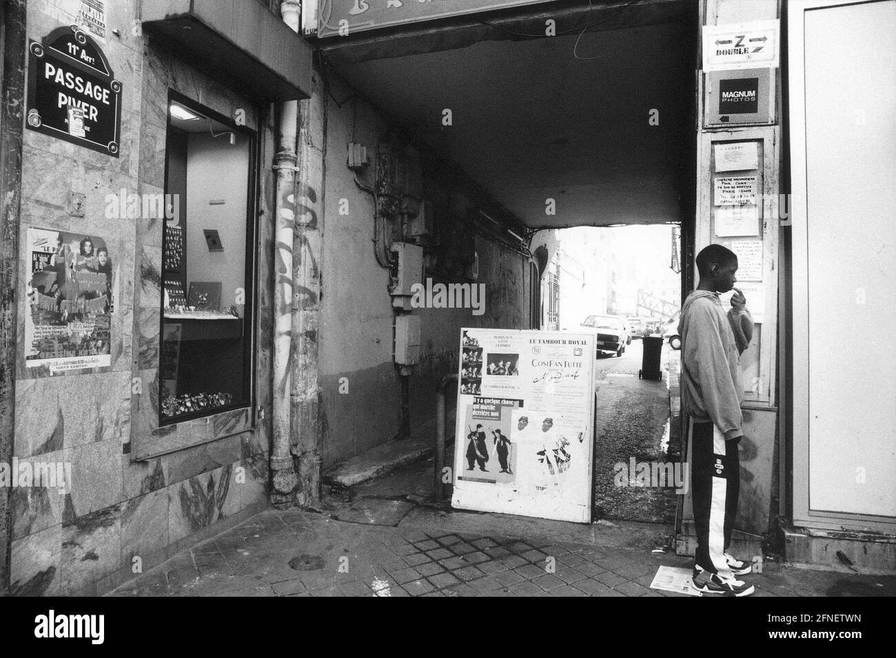 Un ragazzo si trova di fronte a un passaggio nel Piver passaggio, 11 ° arrondissement, nel quartiere Belleville. Sopra i giovani il segno della compagnia 'Magnum Photos'. [traduzione automatizzata] Foto Stock