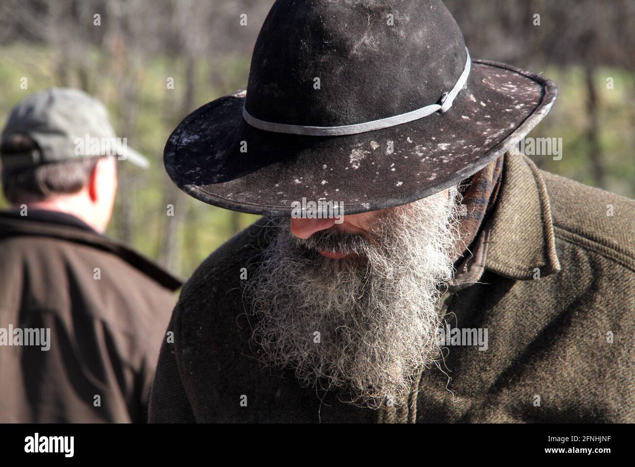Uomo anziano con barba lunga e cappello vecchio feltro Foto stock - Alamy
