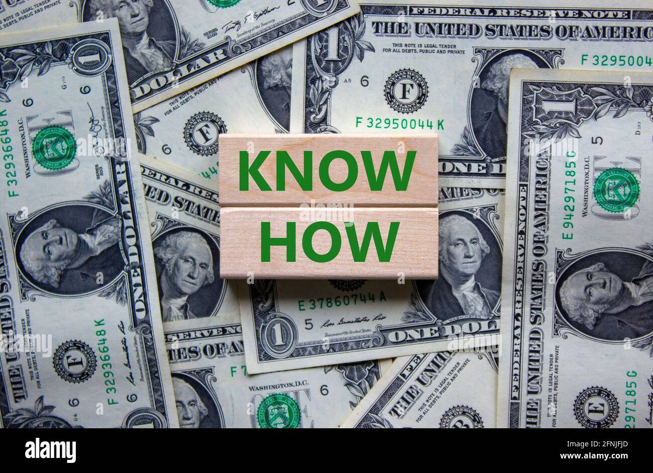 Conoscere il simbolo. Blocchi di legno con le parole 'know how' su sfondo bello da dollari fatture, copia spazio. Business, innovazione e know how concetto. Foto Stock