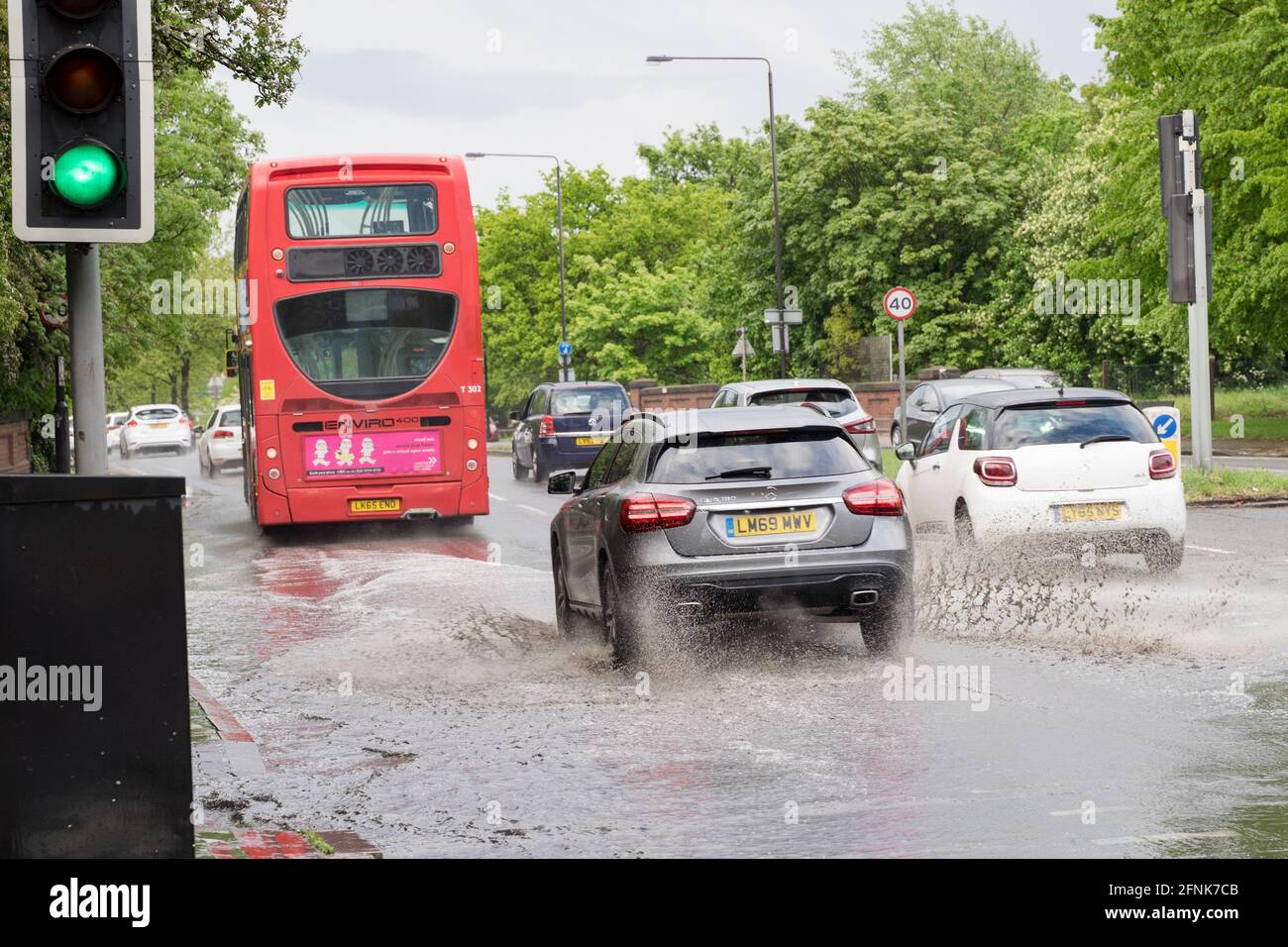 Le auto attraversano un'inondazione di luce sulla South Circular Road, Greater London, England, tempo umido Foto Stock