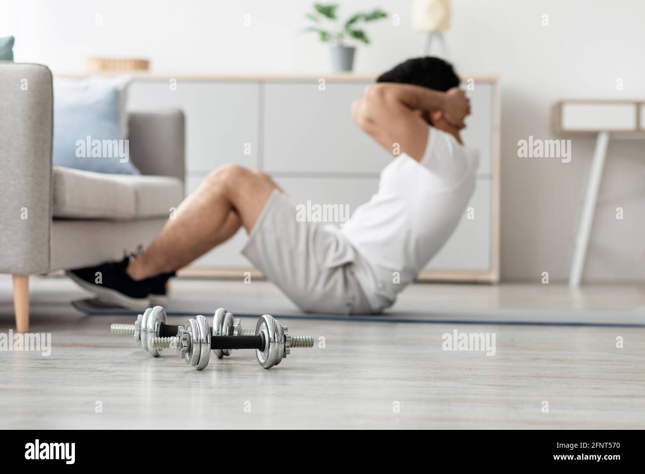 Palestra a casa, sport a tempo libero per il corpo forte muscolare durante covid-19 blocco Foto Stock