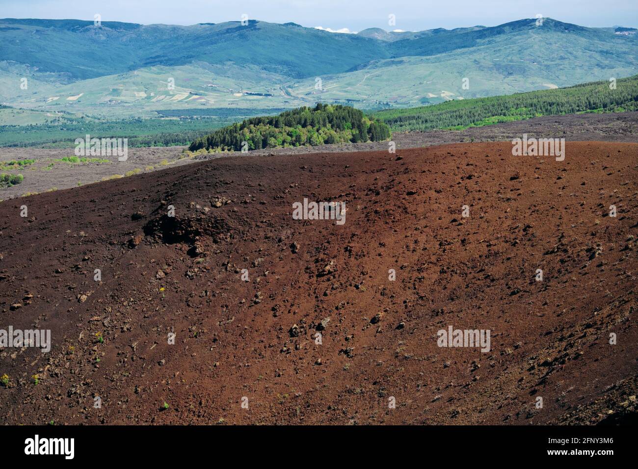 Paesaggio vulcanico in Sicilia bordo di vecchio cratere in Etna Parco sullo sfondo il boscoso Monte Egitto e il Montagne di Nebrodi Foto Stock