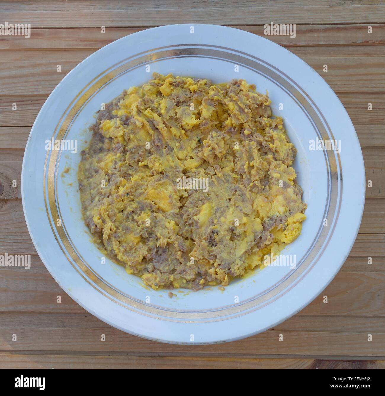 Tuorlo d'uovo mescolato con pesce in scatola, ricetta - nel processo di cottura Foto Stock