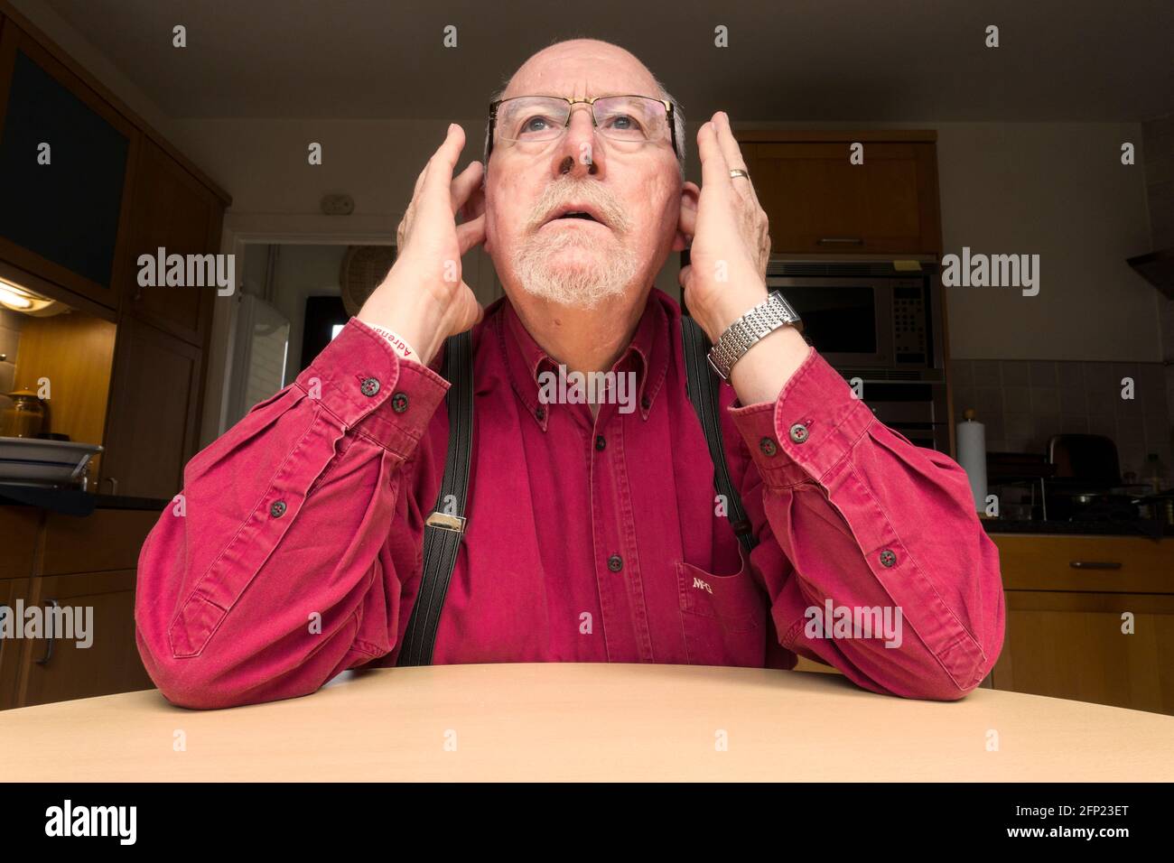 Uomo con le dita nelle orecchie le orecchie, non disposto ad ascoltare o ad ascoltare Foto Stock