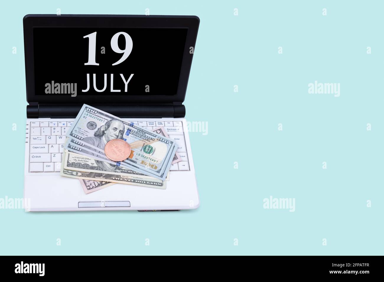 19 luglio. Laptop con la data del 19 luglio e criptovaluta Bitcoin, dollari su sfondo blu. Acquistare o vendere Cryptocurrency. Mercato azionario c Foto Stock