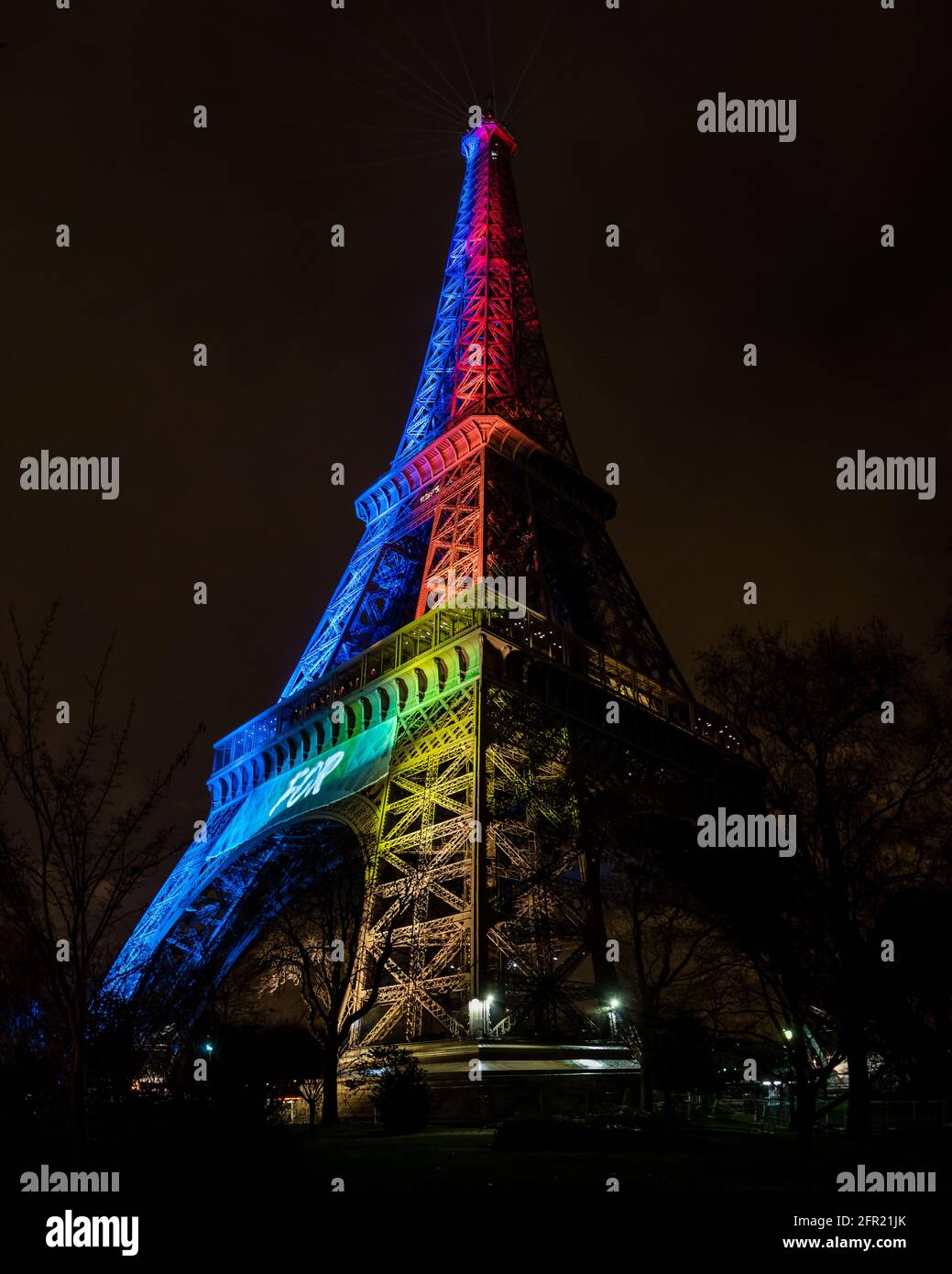 Parigi, Francia - 3 febbraio 2017: Vista verticale alta della Torre Eiffel, illuminata di notte in colori arcobaleno. Ideale per la condivisione Foto Stock