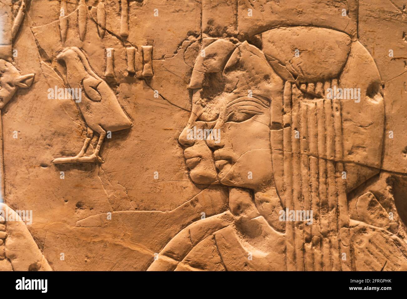 frammento dettagliato della parete di arenaria con particolare attenzione al rilievo dei volti umani Dall'Antico Egitto Foto Stock