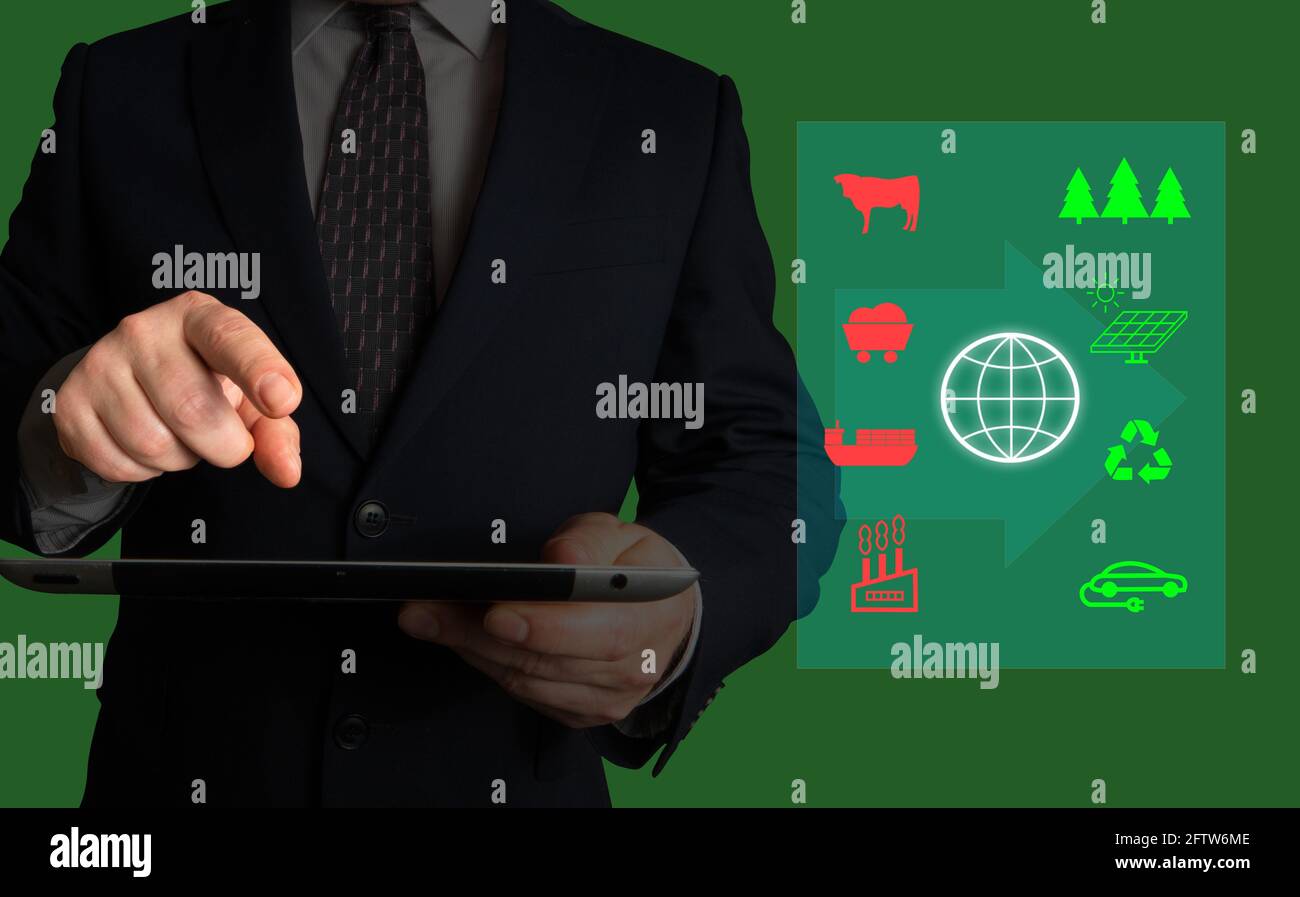 Uomo d'affari in possesso di un tablet con un'immagine che illustra le priorità aziendali in termini di mitigazione del riscaldamento globale. Foto Stock