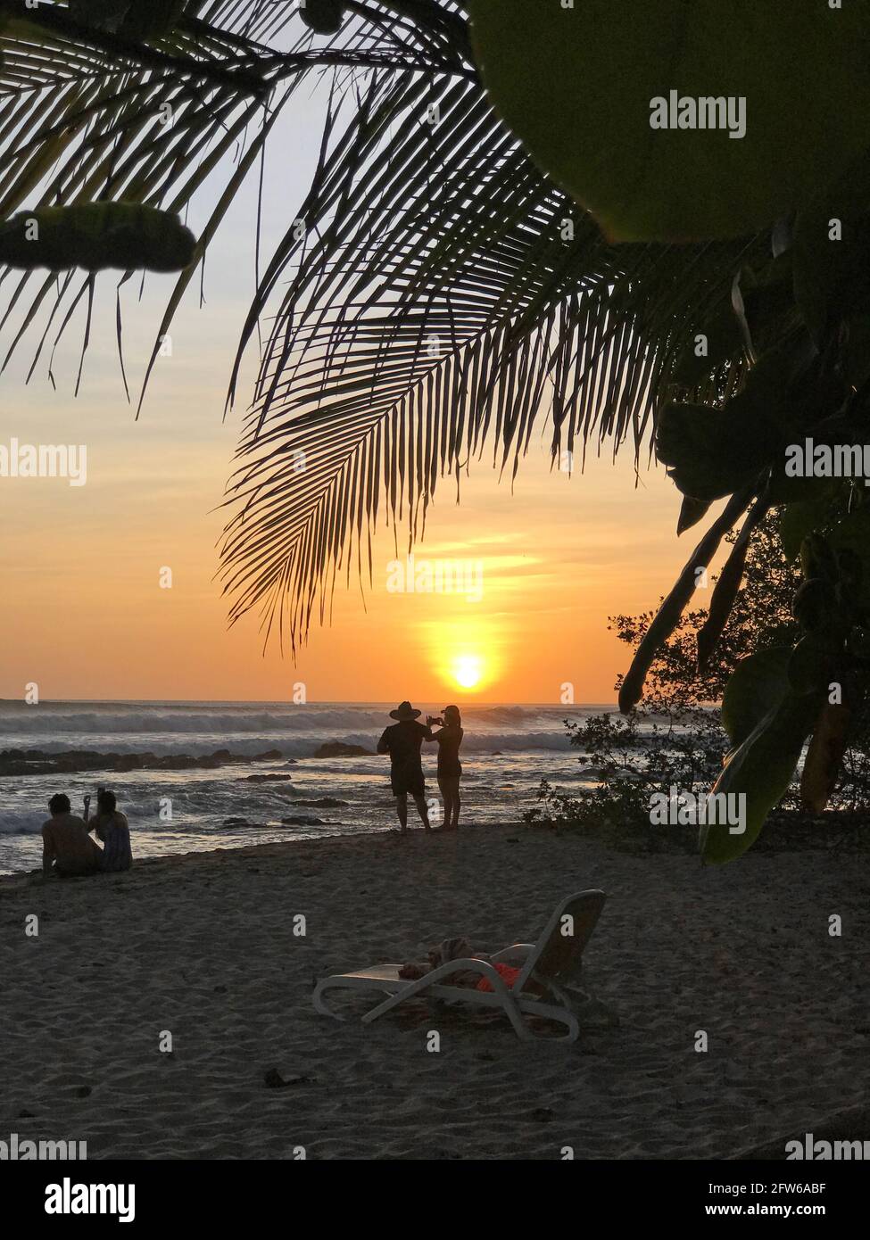 Persone che godono il tramonto da una spiaggia in Costa Rica Foto Stock
