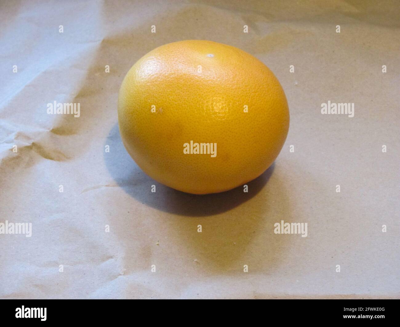 Un pompelmo giallo brillante, maturo e succoso Foto Stock