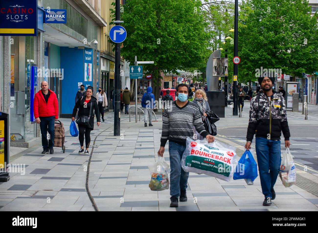 Slough, Berkshire, Regno Unito. 23 maggio 2021. Gli amanti dello shopping oggi a Slough High Street. Il tasso di infezione da rotolamento di sette giorni Covid-19 per 100,000 persone in Slough per la settimana che termina il 18 maggio è salito a 25.4, rispetto a 22.7. Dato che il numero di casi positivi di variante indiana di Covid-19 sta iniziando ad aumentare, la possibile eliminazione di tutte le restrizioni di blocco a giugno potrebbe ora essere in pericolo. Credit: Maureen McLean/Alamy Live News Foto Stock